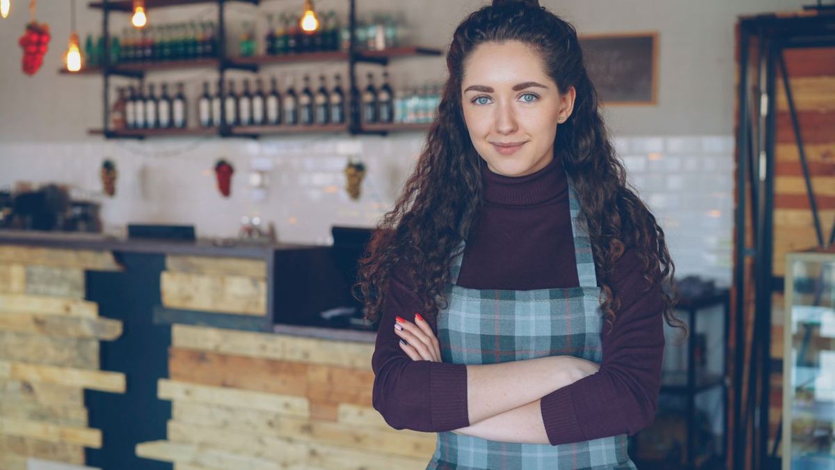 Café owner standing in her coffee shop
